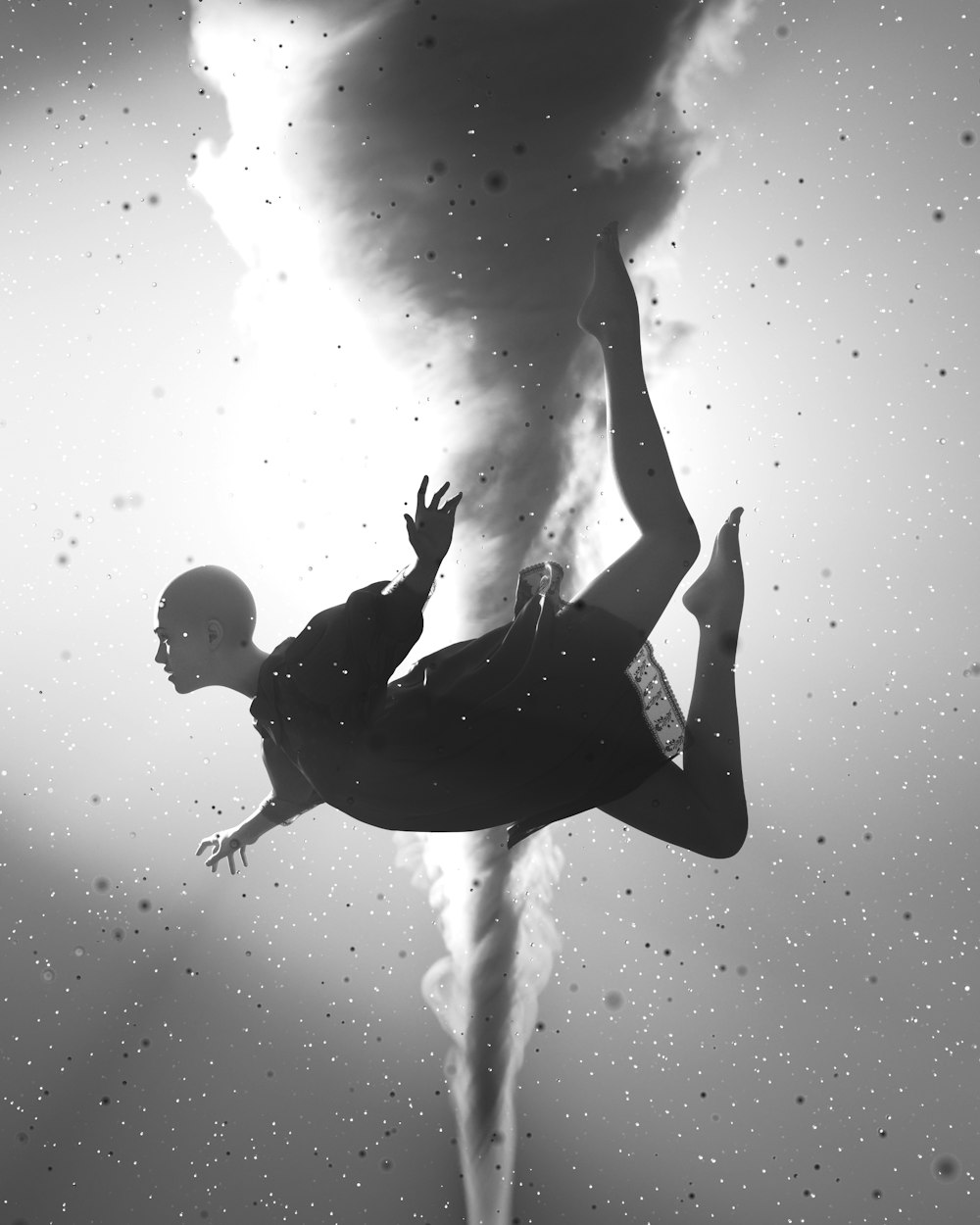 a woman floating in the water under a cloud of smoke