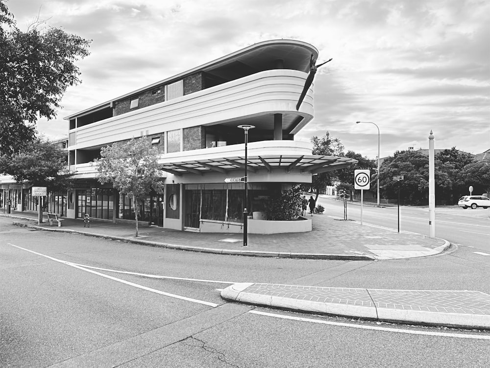 a black and white photo of a building on a street corner