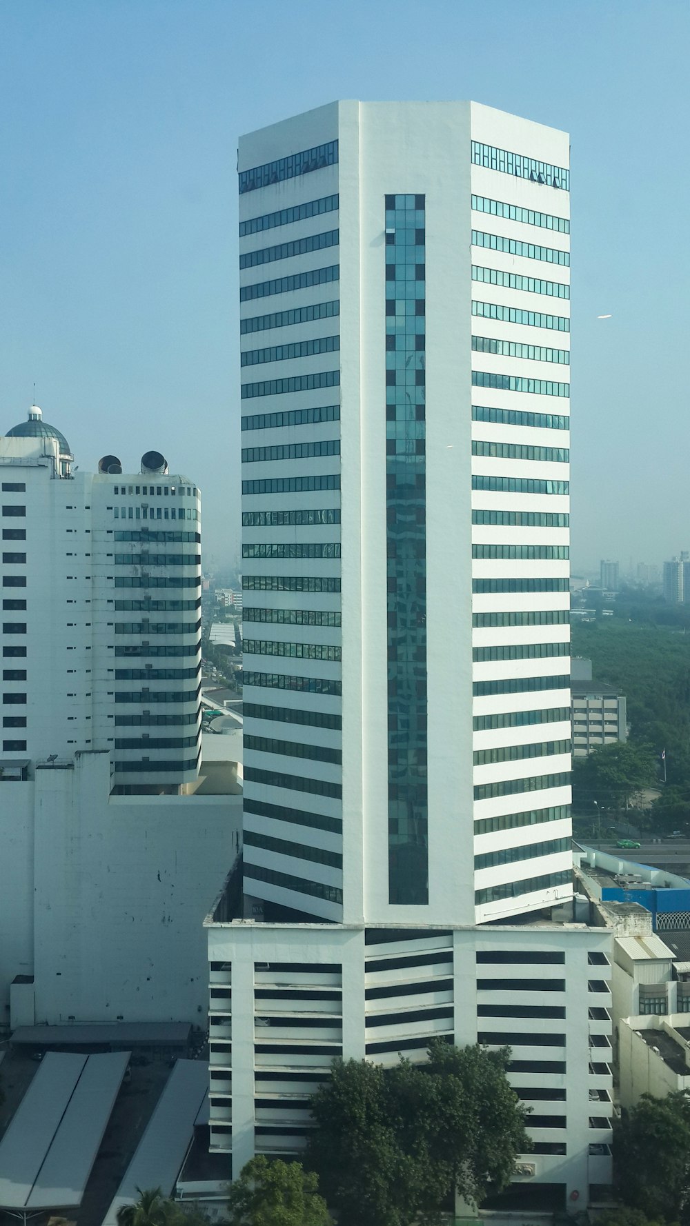 a very tall white building with a lot of windows