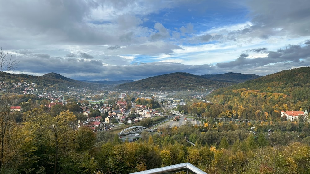 a scenic view of a town in the mountains