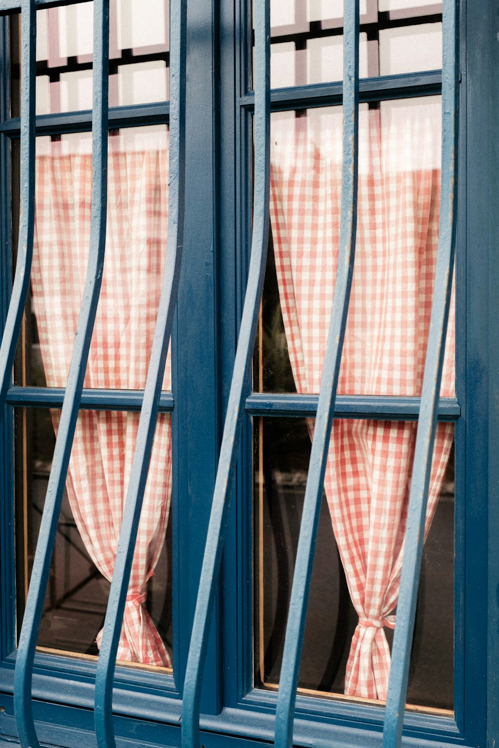 a red and white checkered window with a blue frame
