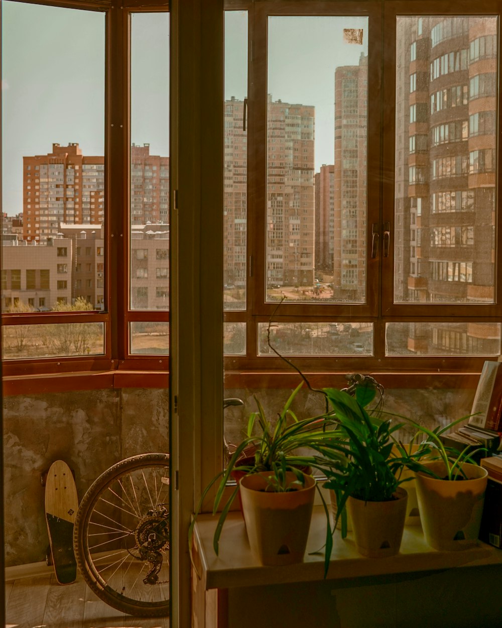 a room with a view of a city and a bicycle