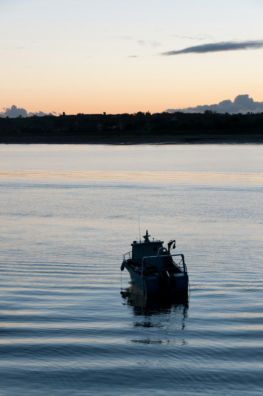 a boat floating on top of a large body of water