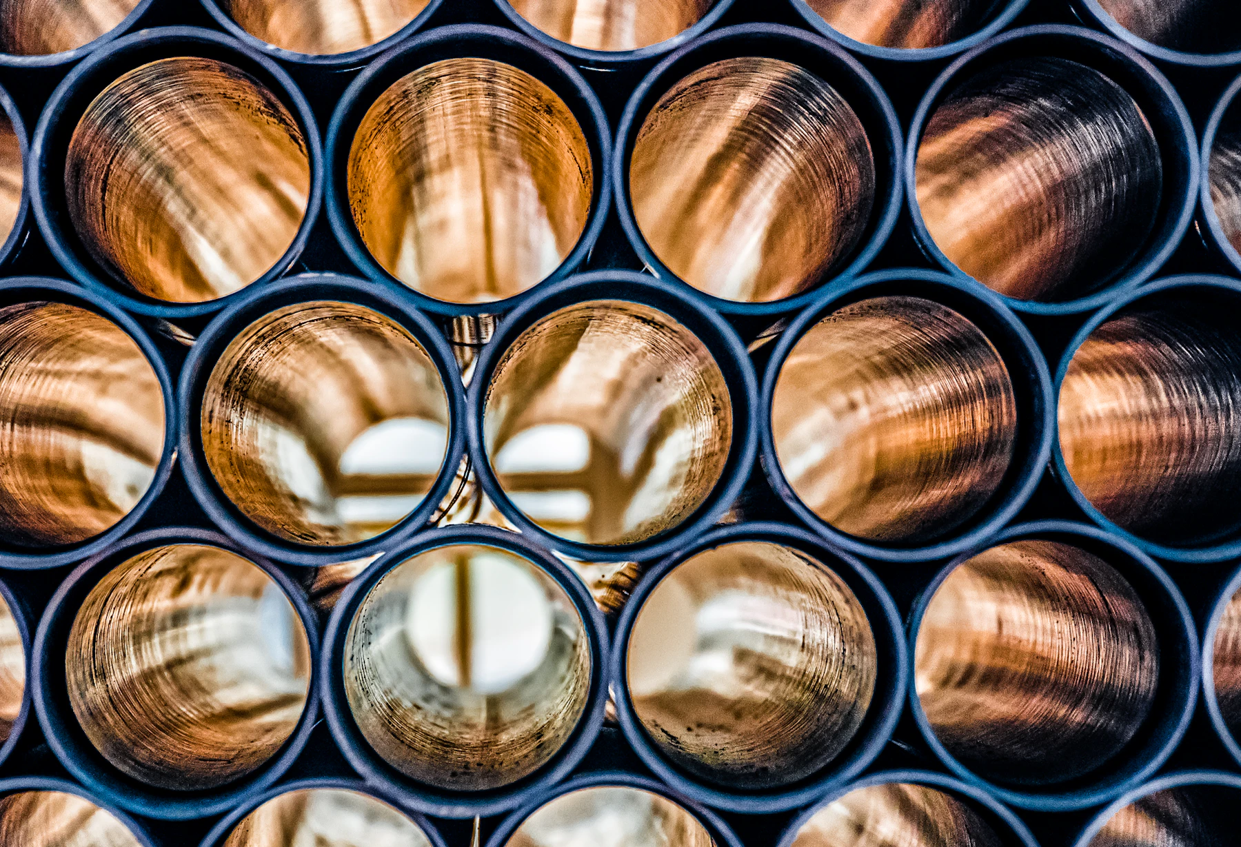 The ends of copper tubes stacked in a tight bundle