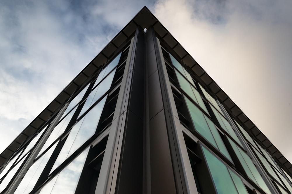 a tall building with lots of windows and a sky background