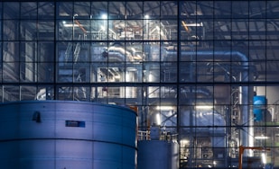 a large building with a lot of pipes in front of it