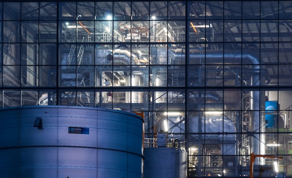 a large building with a lot of pipes in front of it