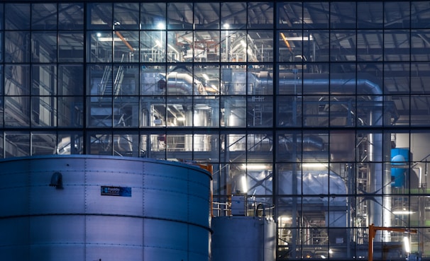 a large building with a lot of pipes in front of it