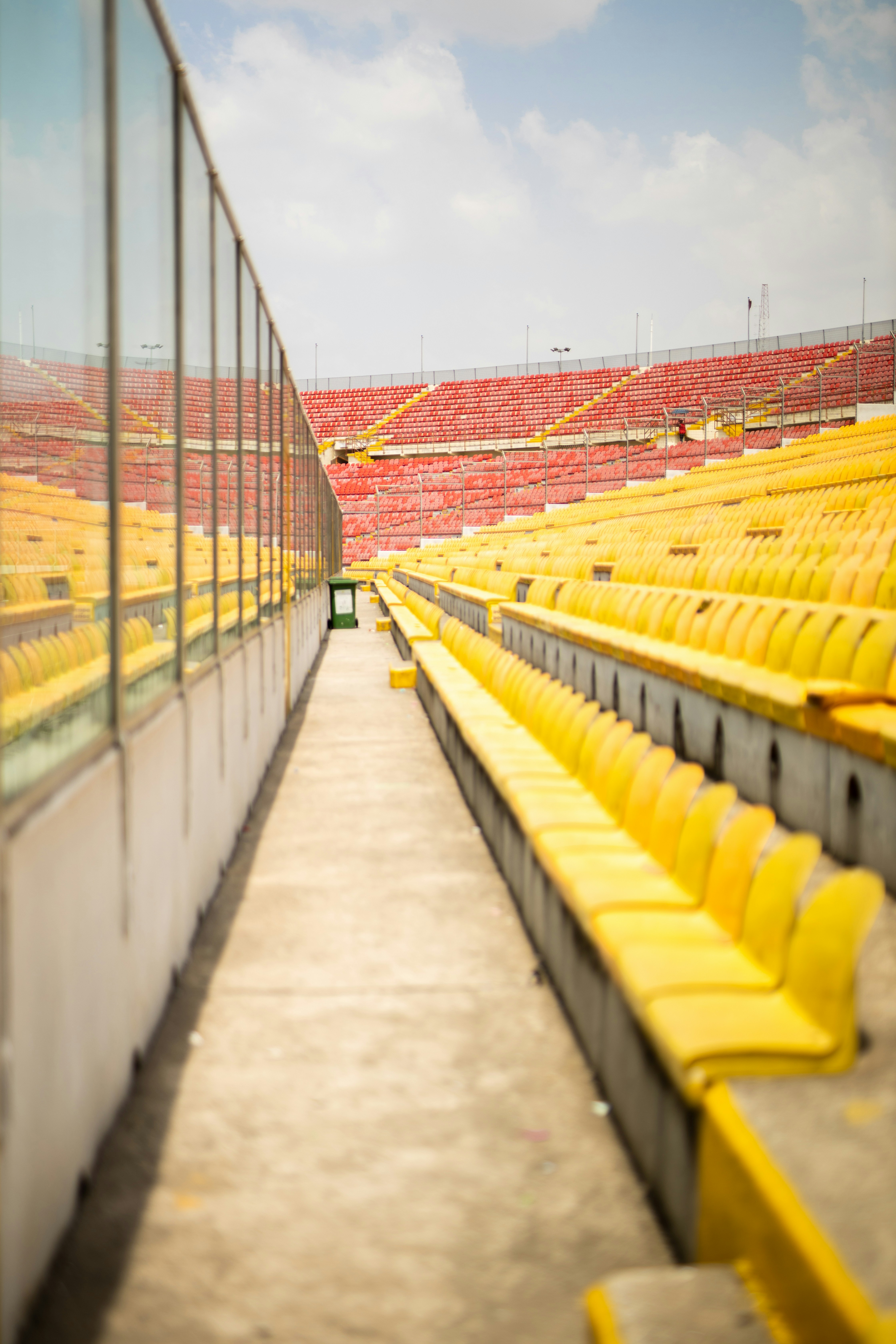 a row of empty yellow seats in a stadium