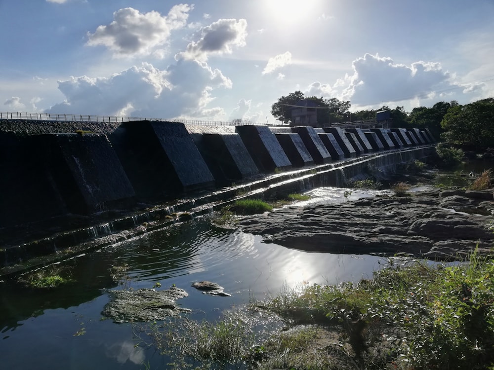 the sun is shining over a dam