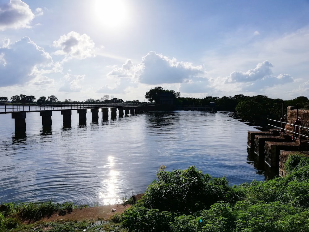 a large body of water with a bridge in the background