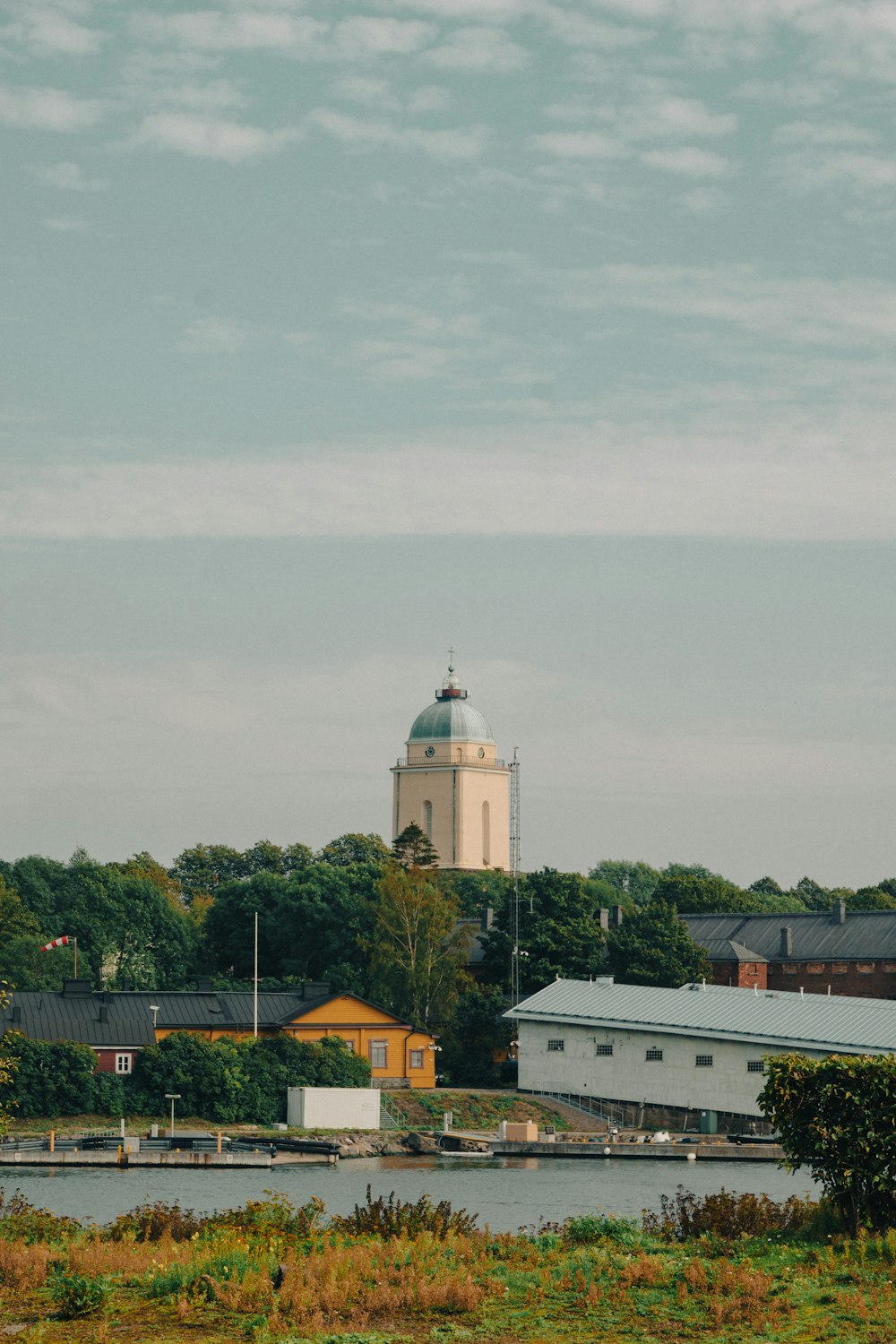 a white building with a clock tower in the background