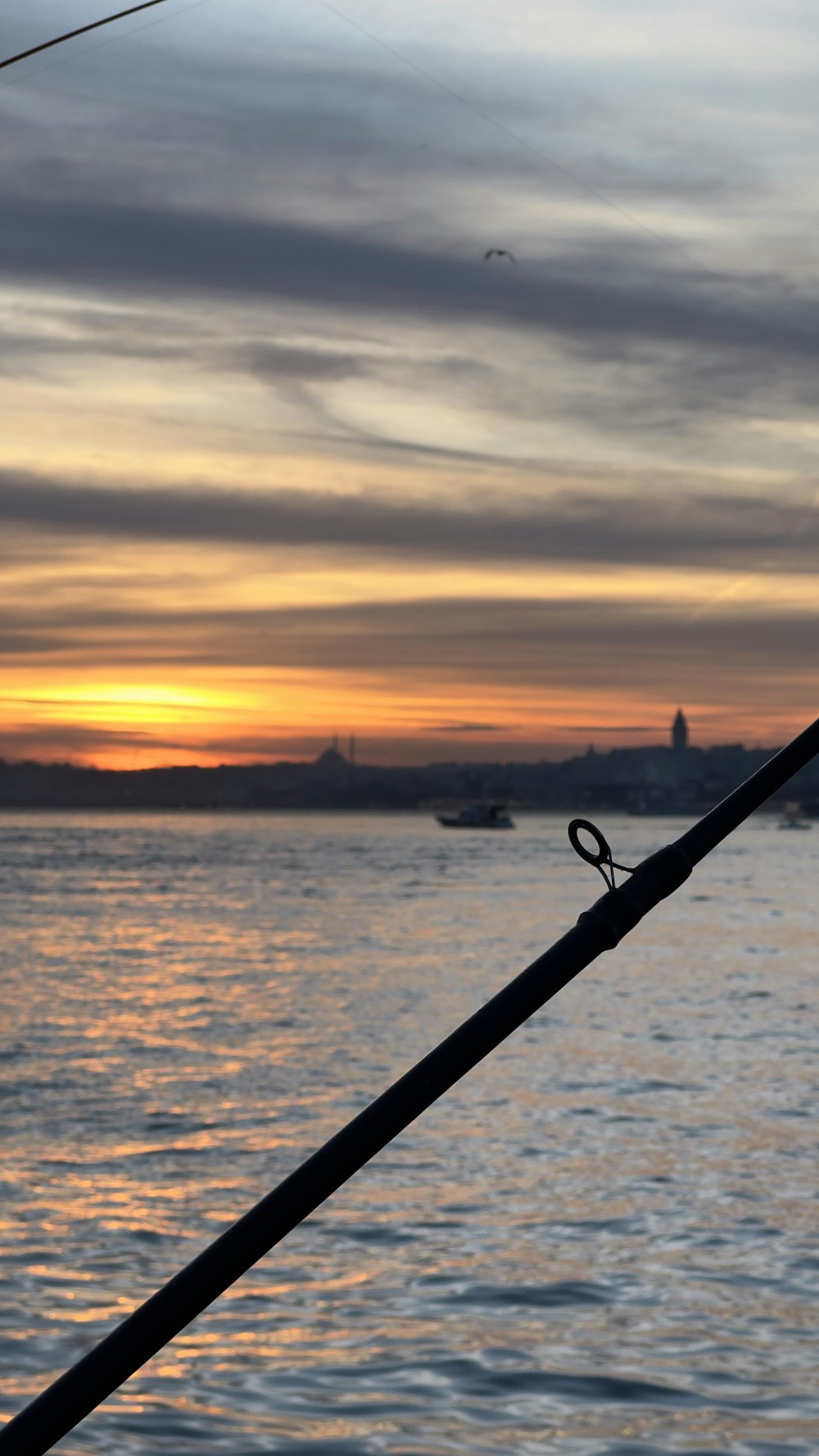 a boat is sailing in the water at sunset