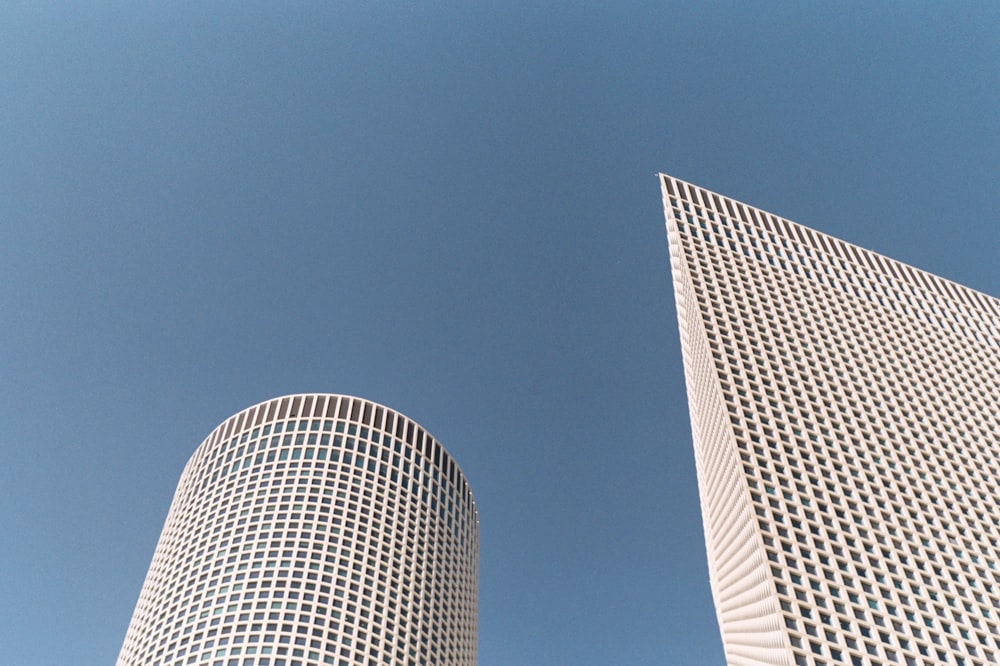 a couple of tall buildings sitting next to each other