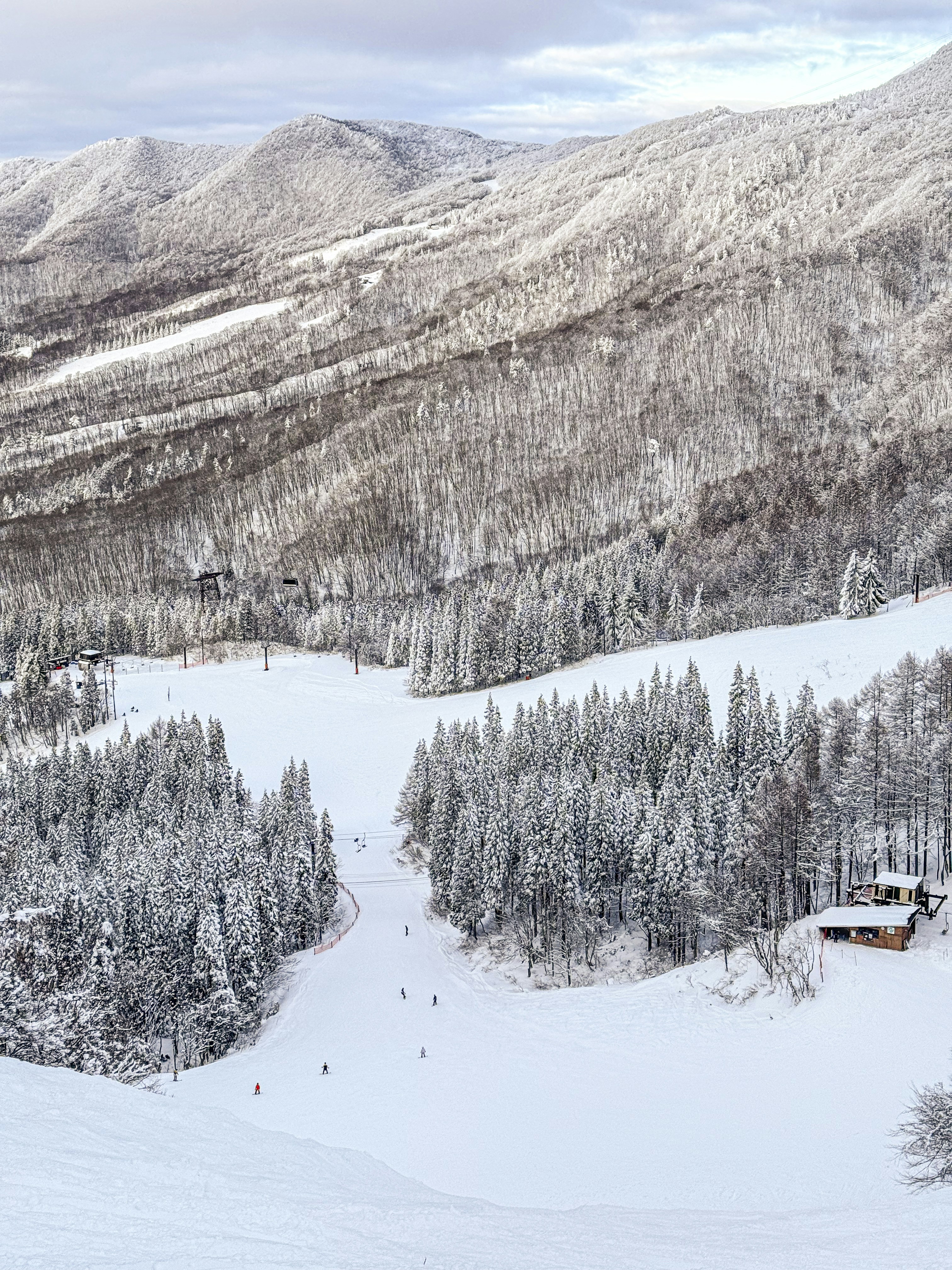 a snow covered mountain with a ski lodge in the distance