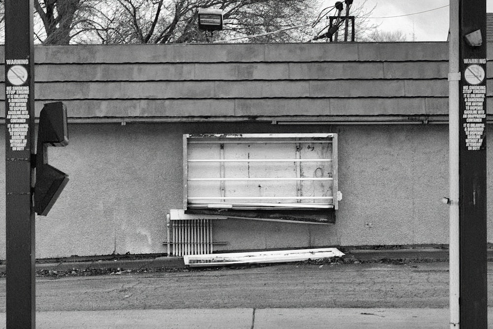 a black and white photo of a building with a broken window