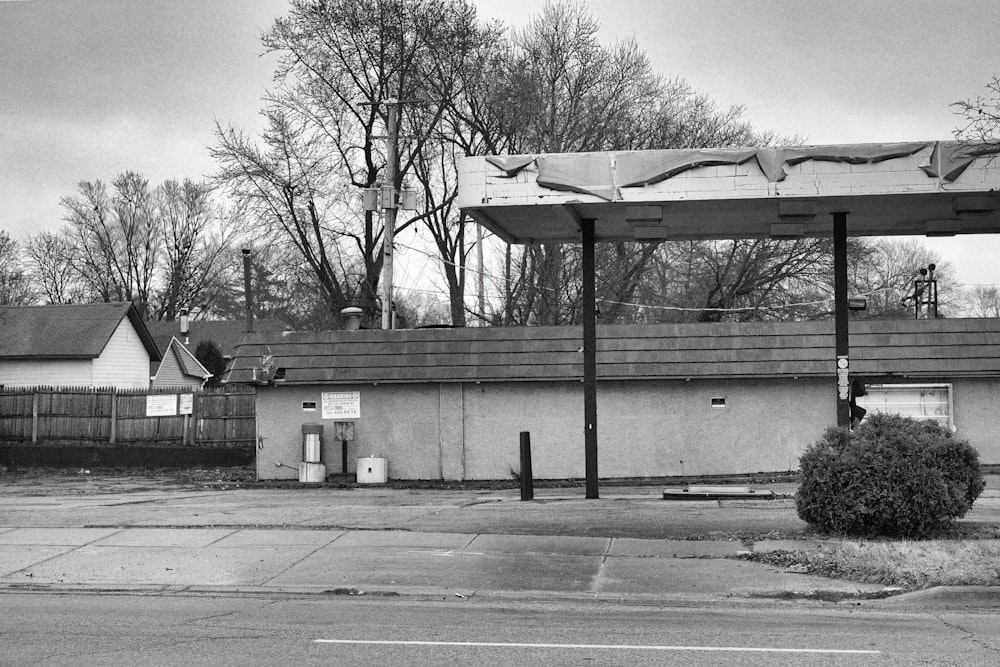 a black and white photo of a gas station