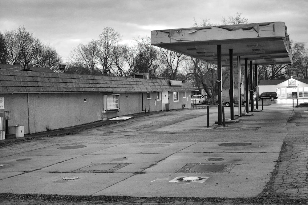 a black and white photo of a gas station