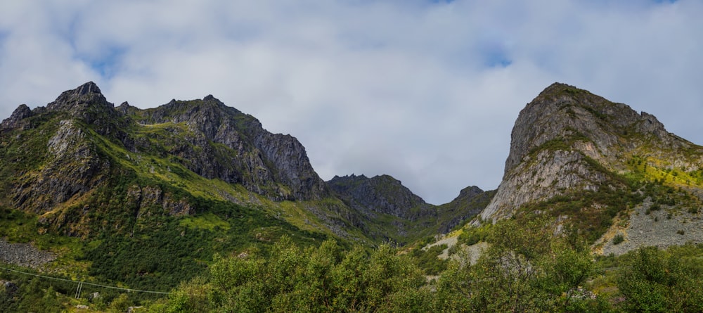 a view of a mountain range from the bottom of a hill