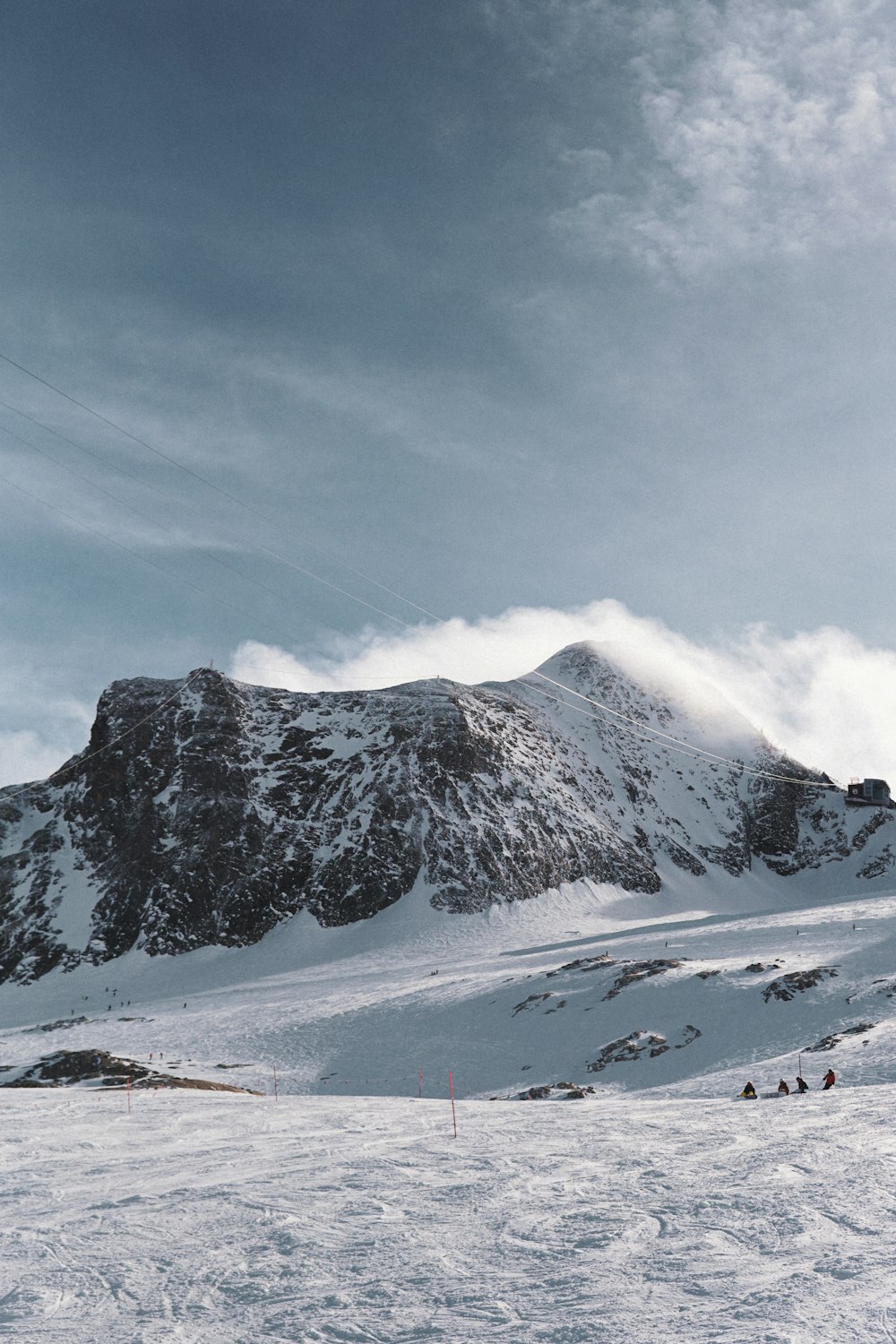 a group of people riding skis on top of a snow covered slope