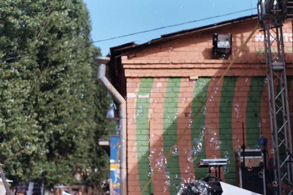 a man riding a snowboard down a street next to a building