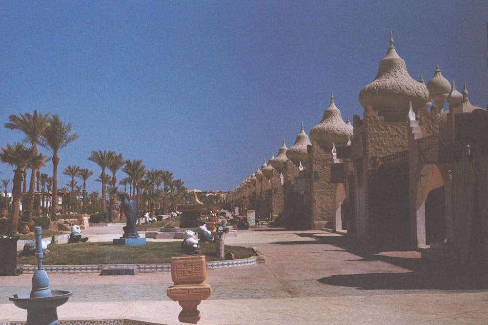 a courtyard with a fountain and palm trees