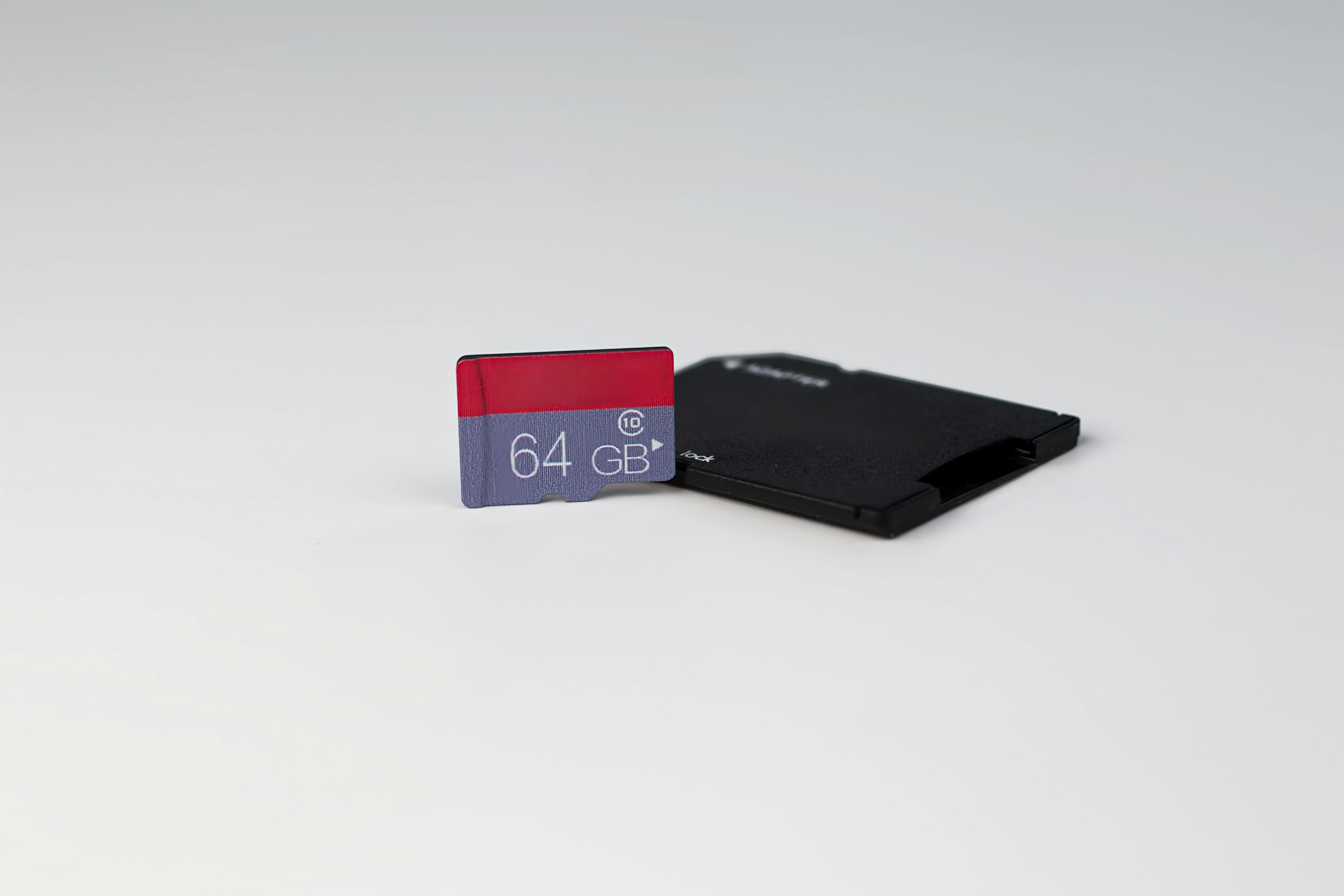 a black and red credit card sitting on top of a white table