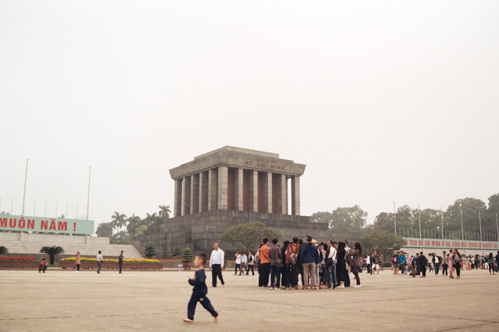 a group of people standing in front of a building