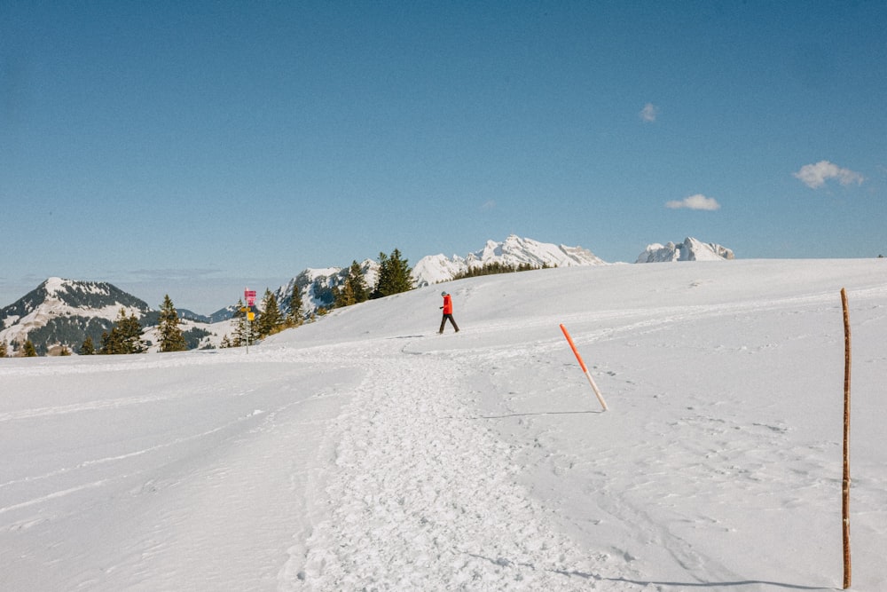 a man riding skis down a snow covered slope