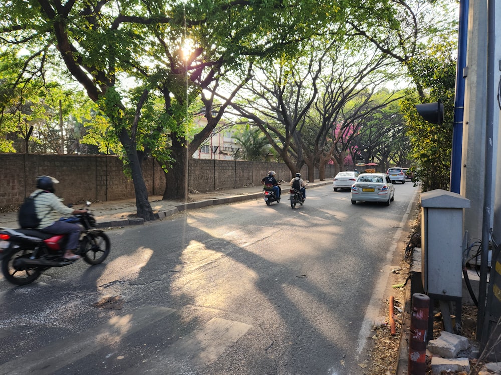 a group of people riding motorcycles down a street