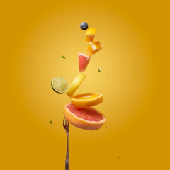 a piece of fruit falling off of a fork