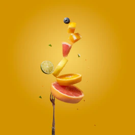 a piece of fruit falling off of a fork