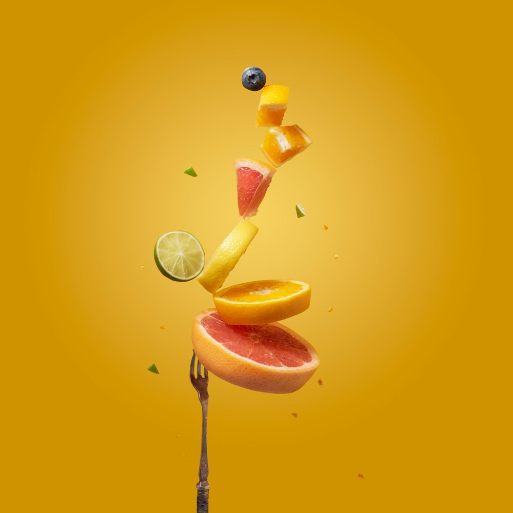 a piece of fruit falling off of a fork