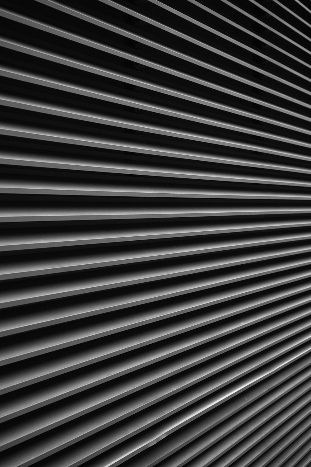 a black and white photo of a metal wall