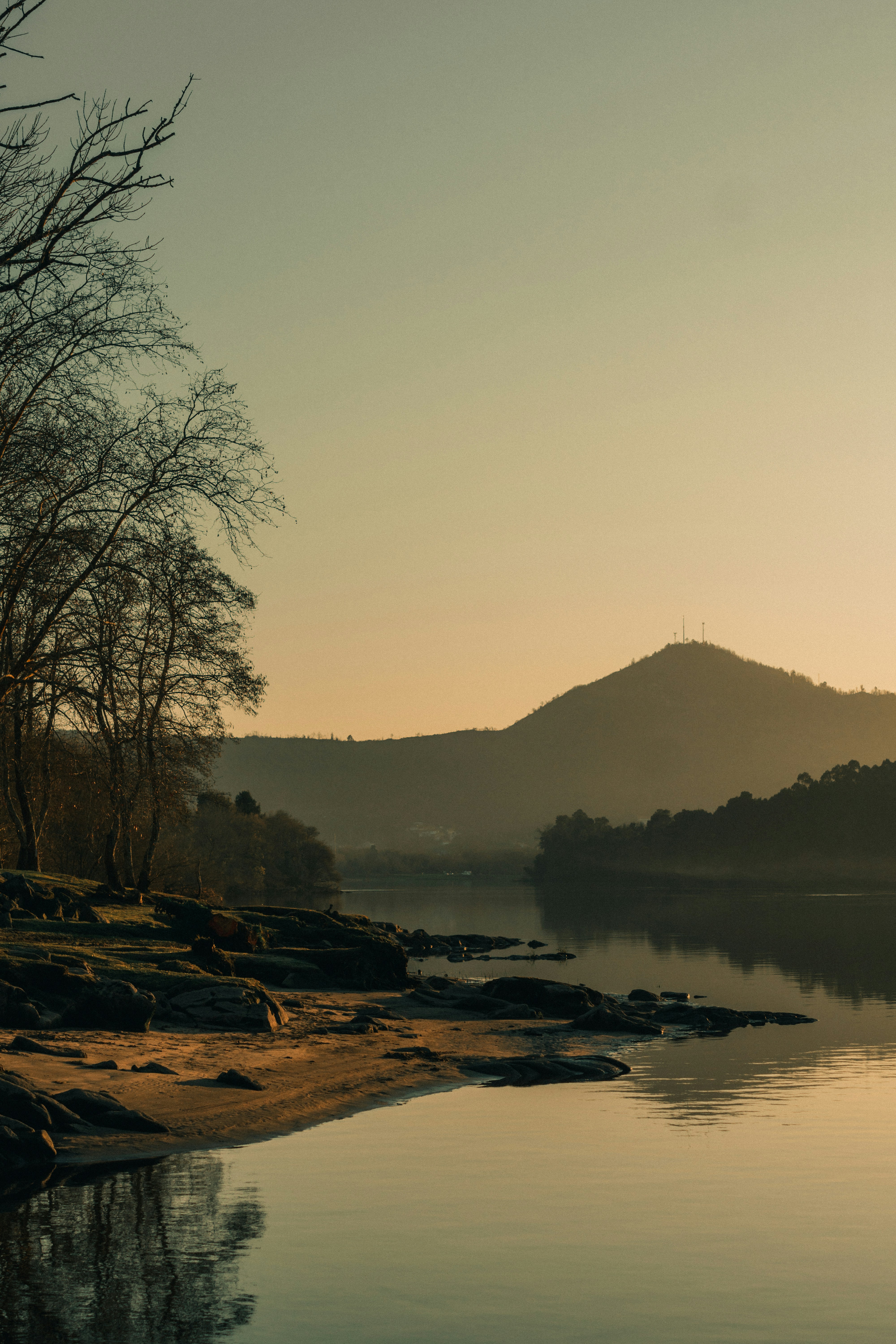 a body of water with a mountain in the background