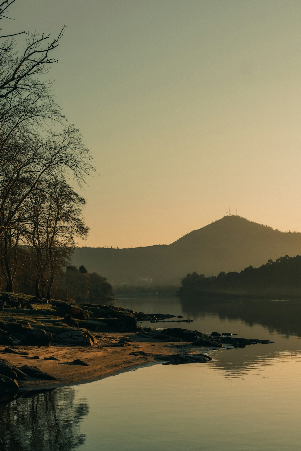 a body of water with a mountain in the background