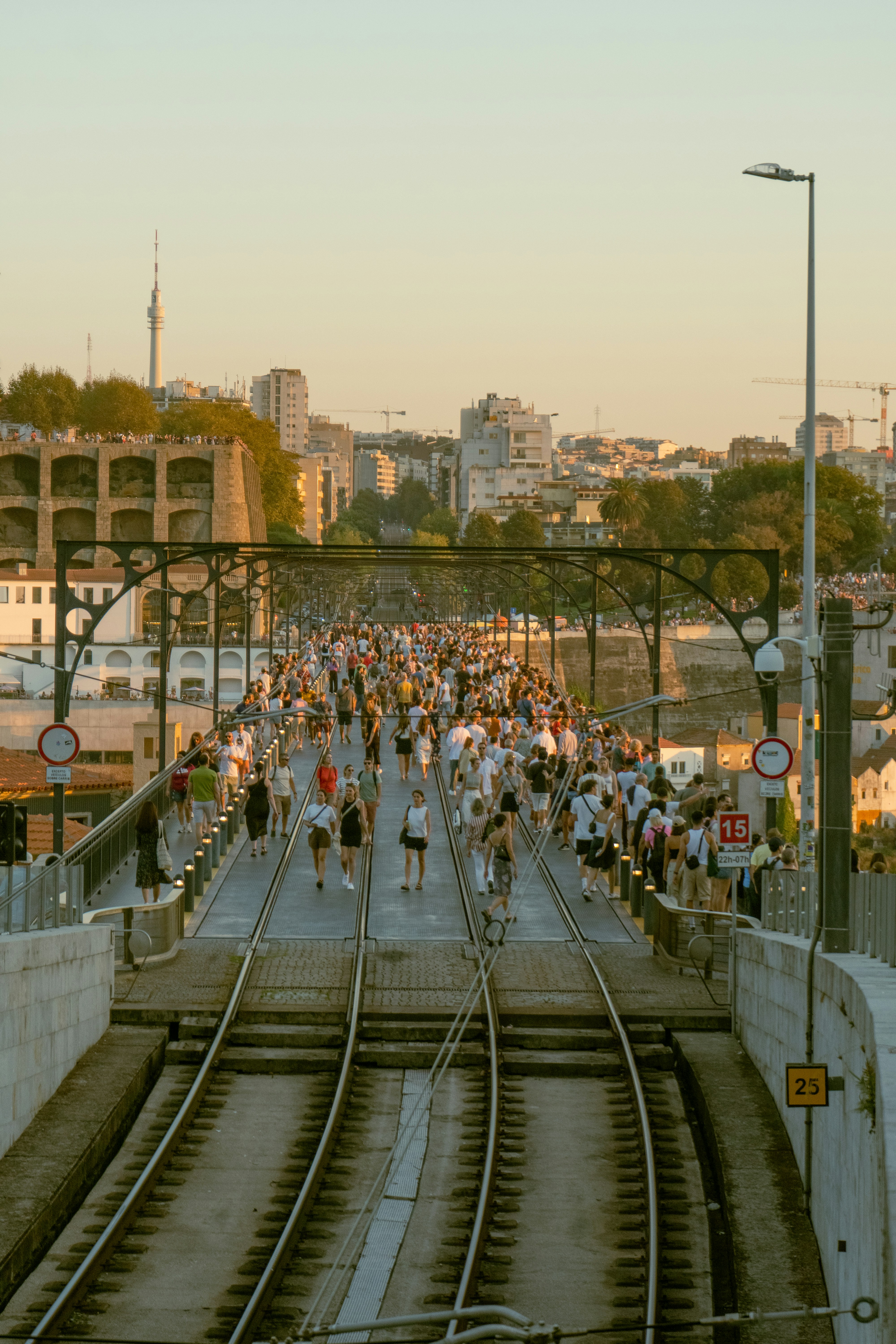 a large group of people running down a train track