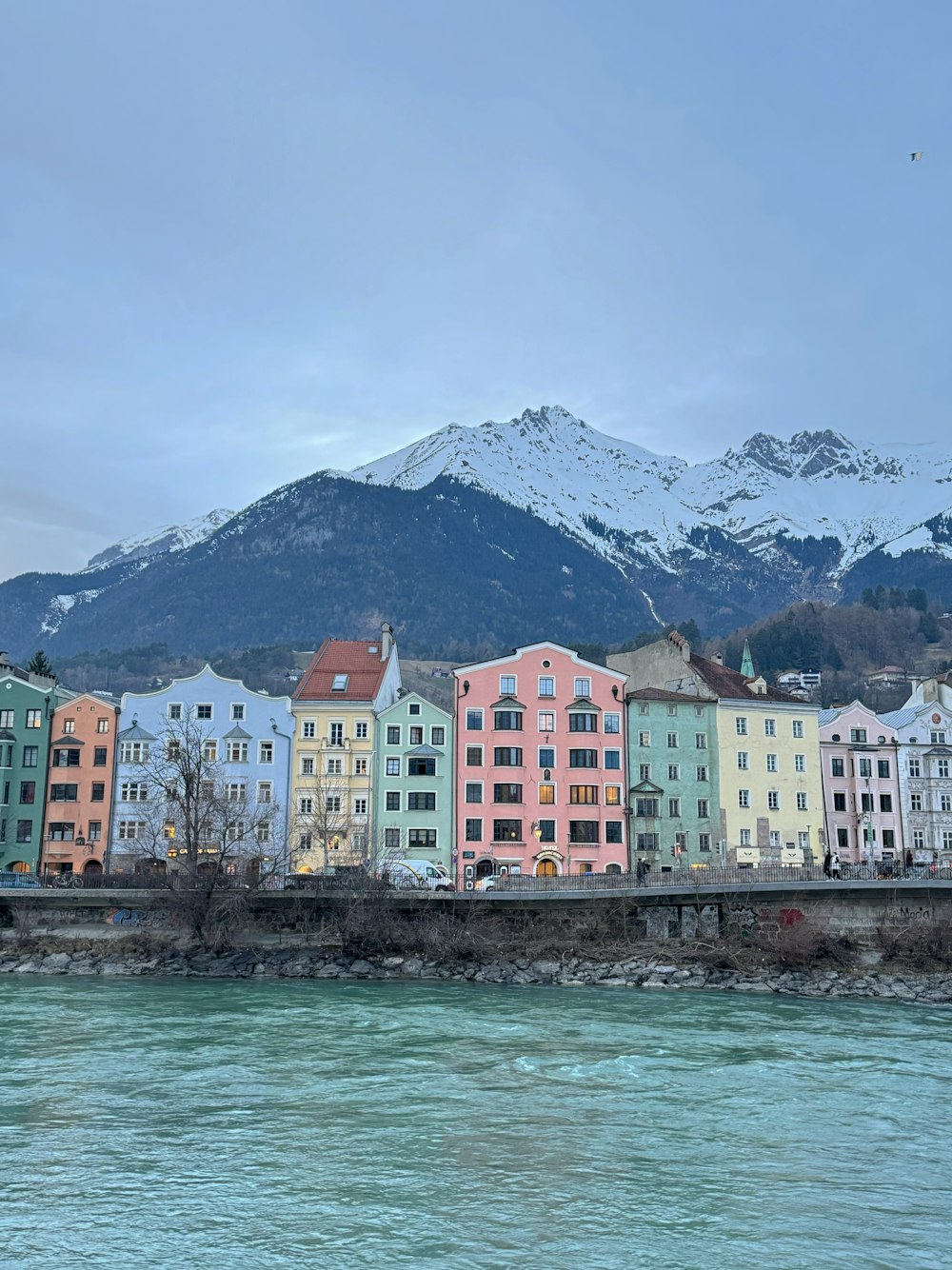 a bunch of buildings that are next to a body of water