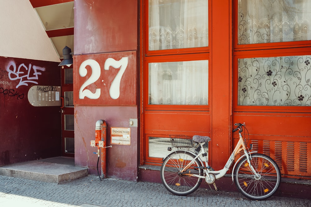 a bike parked in front of a red building