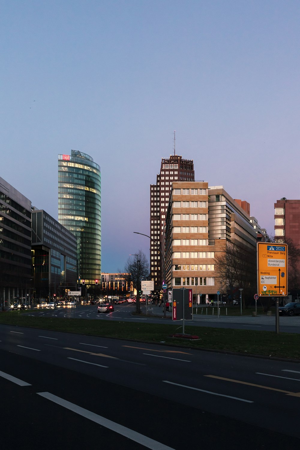 a view of a city street with tall buildings in the background