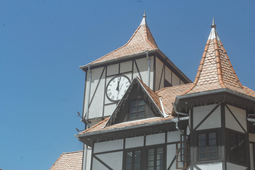 a clock on the side of a building with a sky background