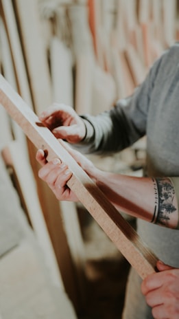 a person holding a wooden stick in their hands