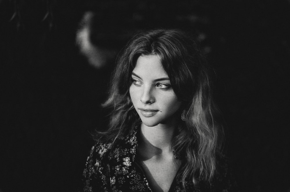 a black and white photo of a woman with long hair