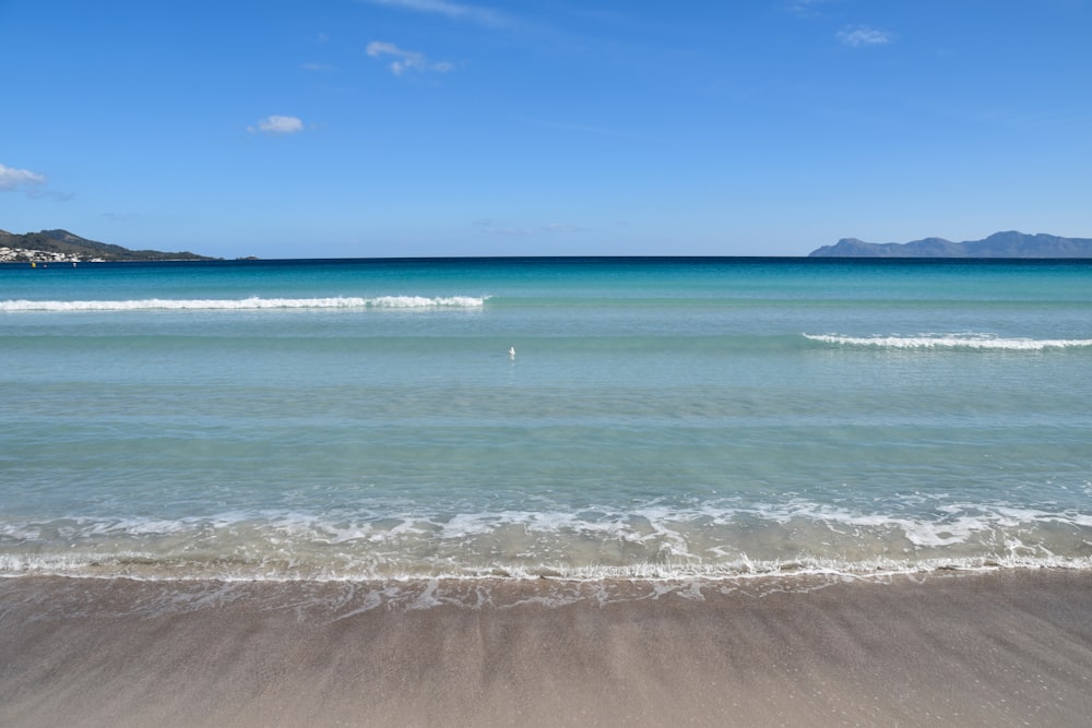 a view of the ocean from the shore of a beach