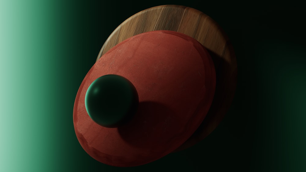 a close up of a red object on a green background
