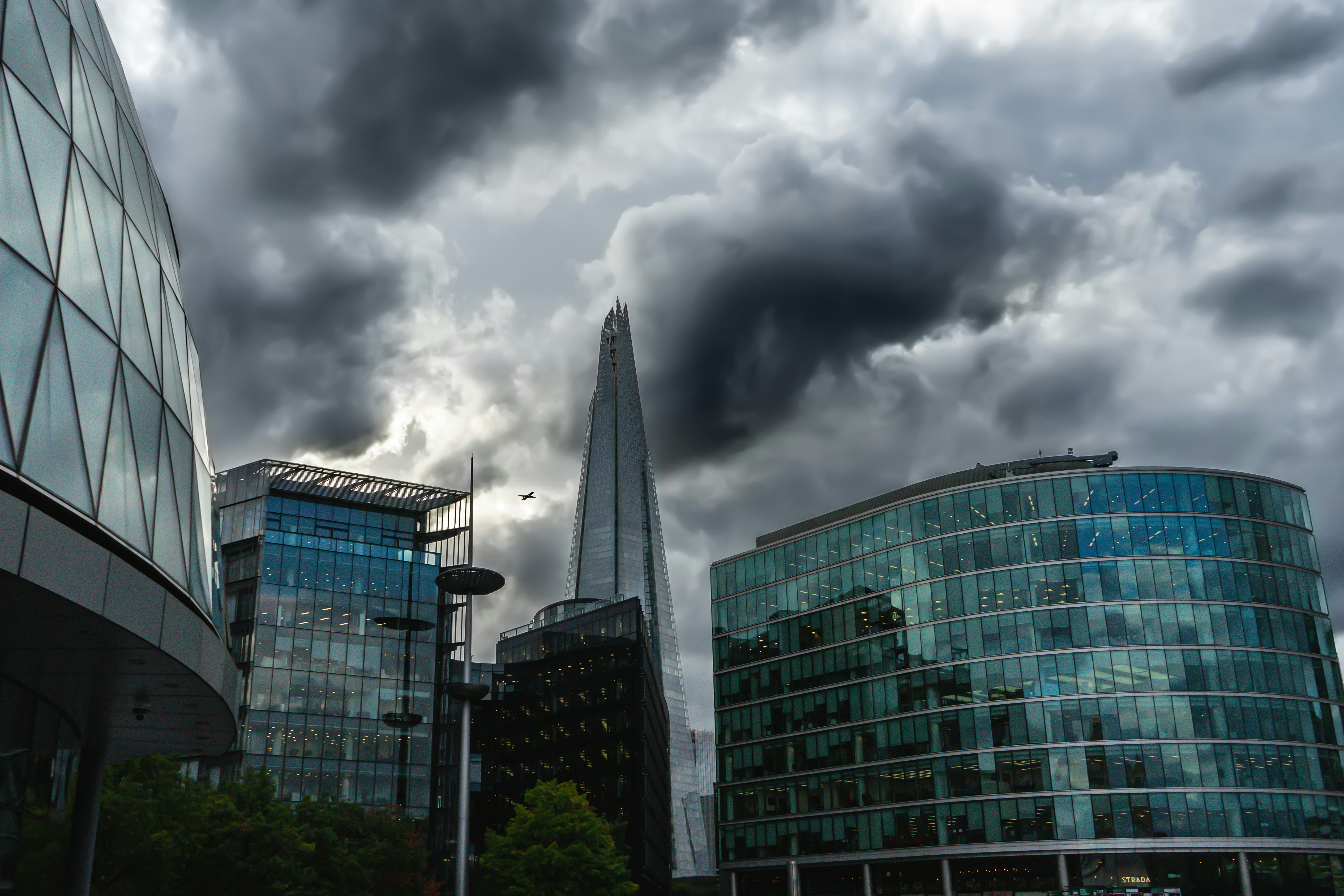 a cloudy sky over a city with skyscrapers
