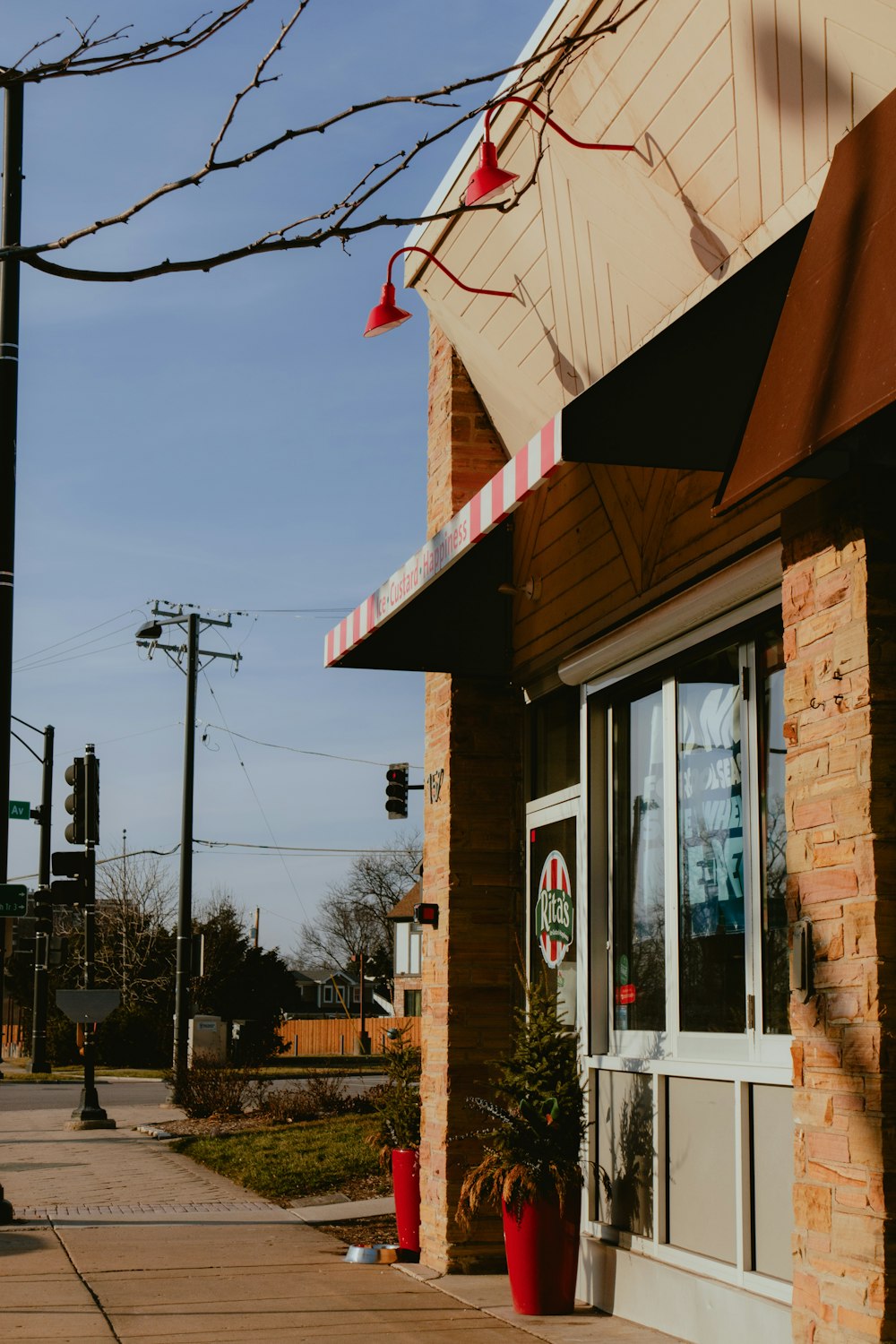 a building with a red awning next to a sidewalk