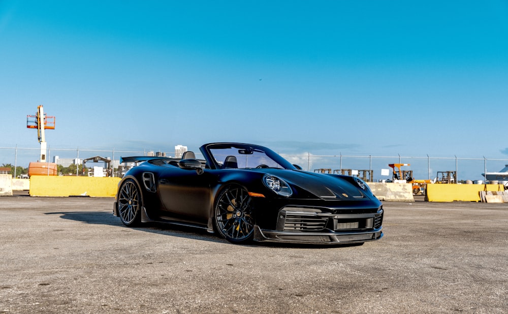 a black sports car parked in a parking lot