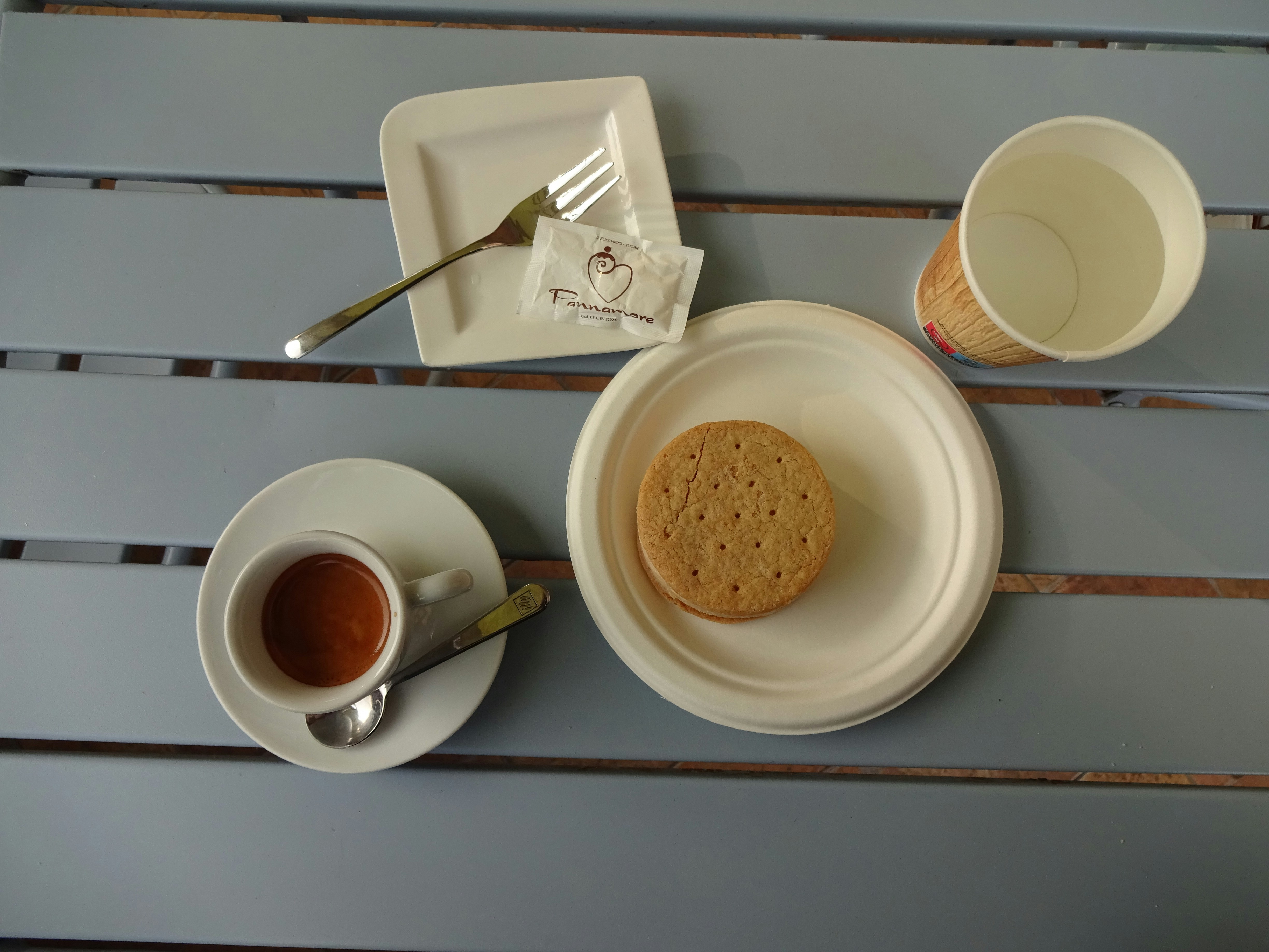 a plate with a cookie and a cup of coffee