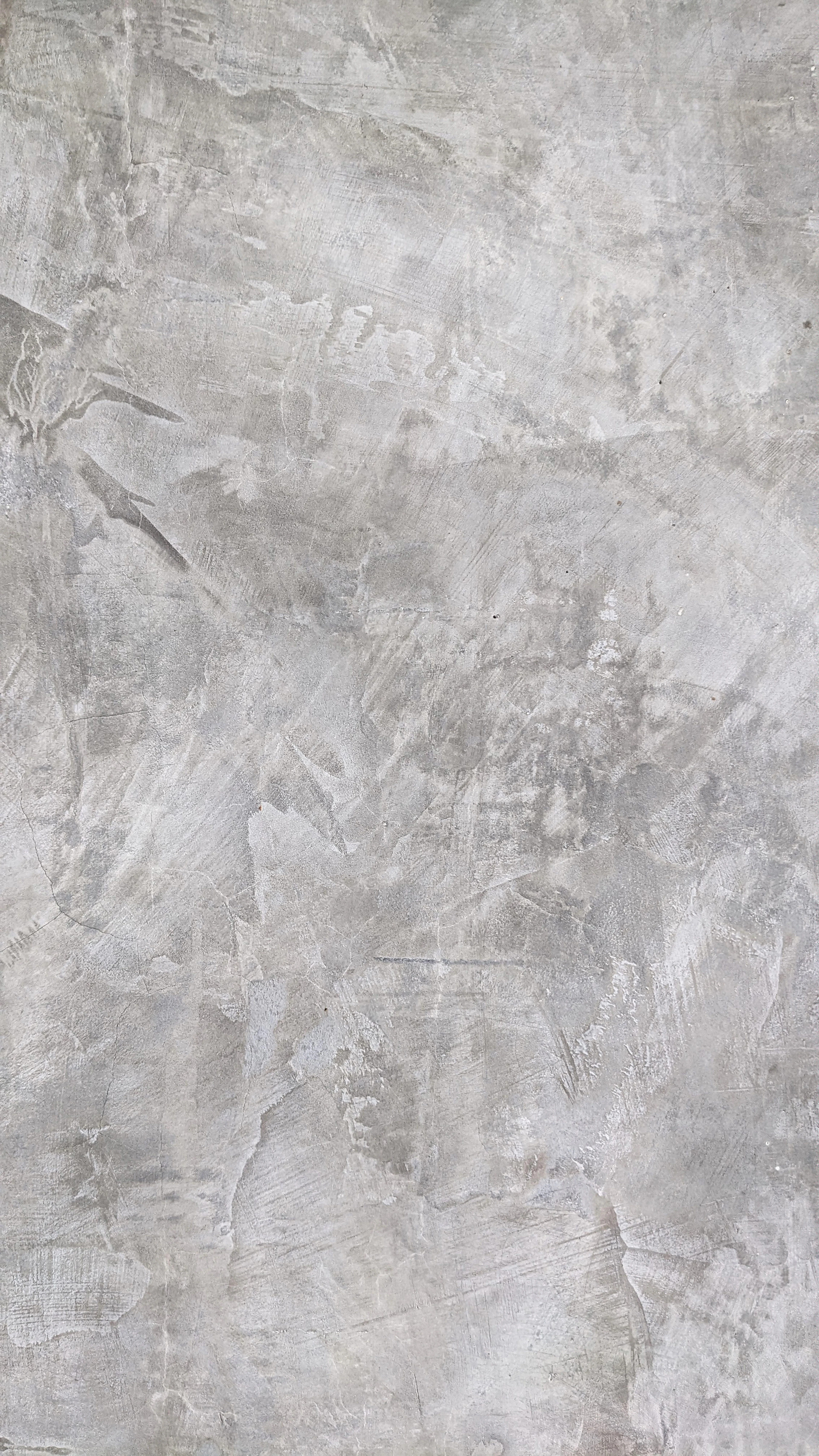 Close view of hand-trowelled grey lime plaster with soft tonal movement